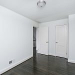 a white room with dark hard wood floors
