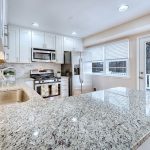 a new kitchen with clean stone counters