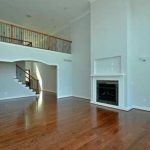 empty family room with stairs and fireplace